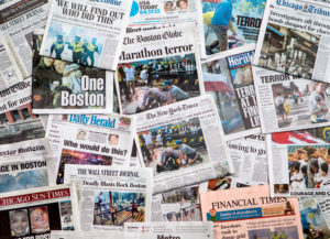 A stack of newspapers with headlines decrying the bombing at the Boston Marathon