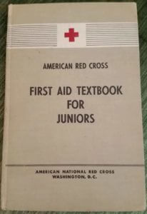 Photo of the cover of American Red Cross 1949 First aid textbook for juniors