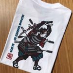 The back of the Samurai t-shirt showing a Samurai, bloodied in battle, broken sword raised, and shot up with arrows, but continuing to fight