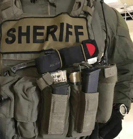 SWAT operator with red-tipped CAT tourniquet on his gear