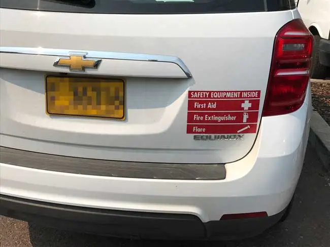 Utilities vehicle with emergency gear placard