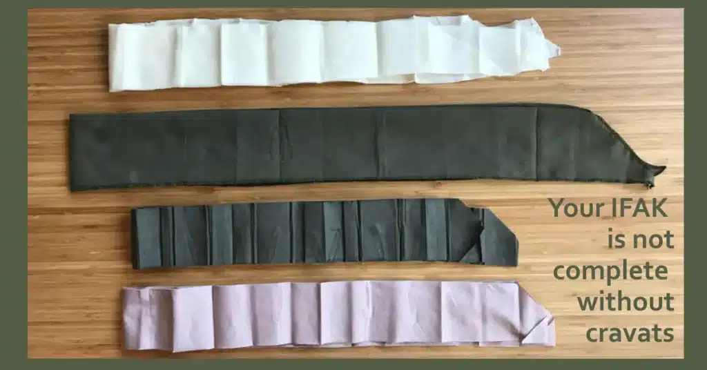 A bamboo table with four different cravats laid out on it