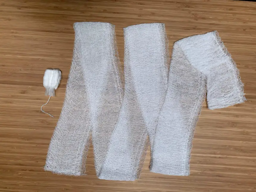 A side by side comparison with one super absorbent tampon, compared to a roll of standard Kerlix gauze.