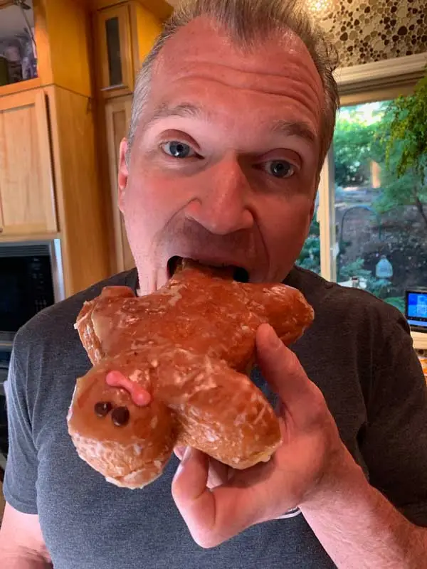 A savage attacking the Happy Little Dough Boy, ripping him from his bakery box and amputating his limb.