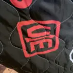 a closeup of the CM Chop with arrow on our new, limited edition poncho liners