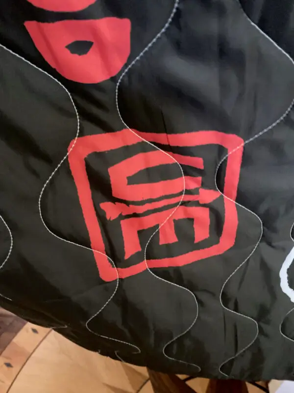 a closeup of the CM Chop with arrow on our new, limited edition poncho liners