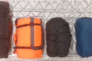 Co-TCCC guideline update hypothermia management showing a sleeping bag, HPMK, and other options