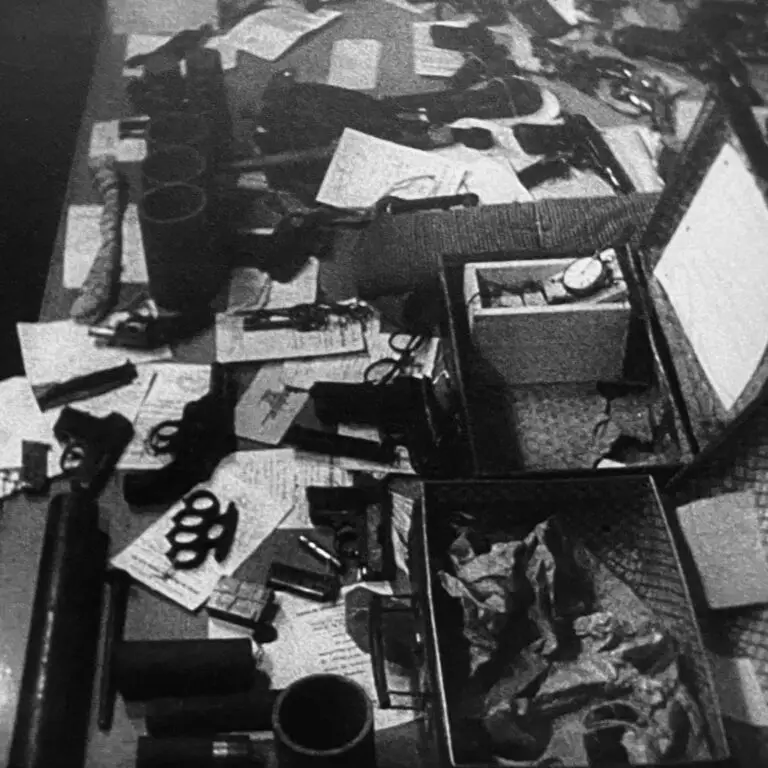 A grainy black and white photograph from WWII of resistance fighters battlefield recovered weapons