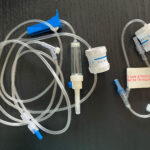 Photo showing Dial-a-Flow hooked up to both extension tubing and to IV tubing kit.
