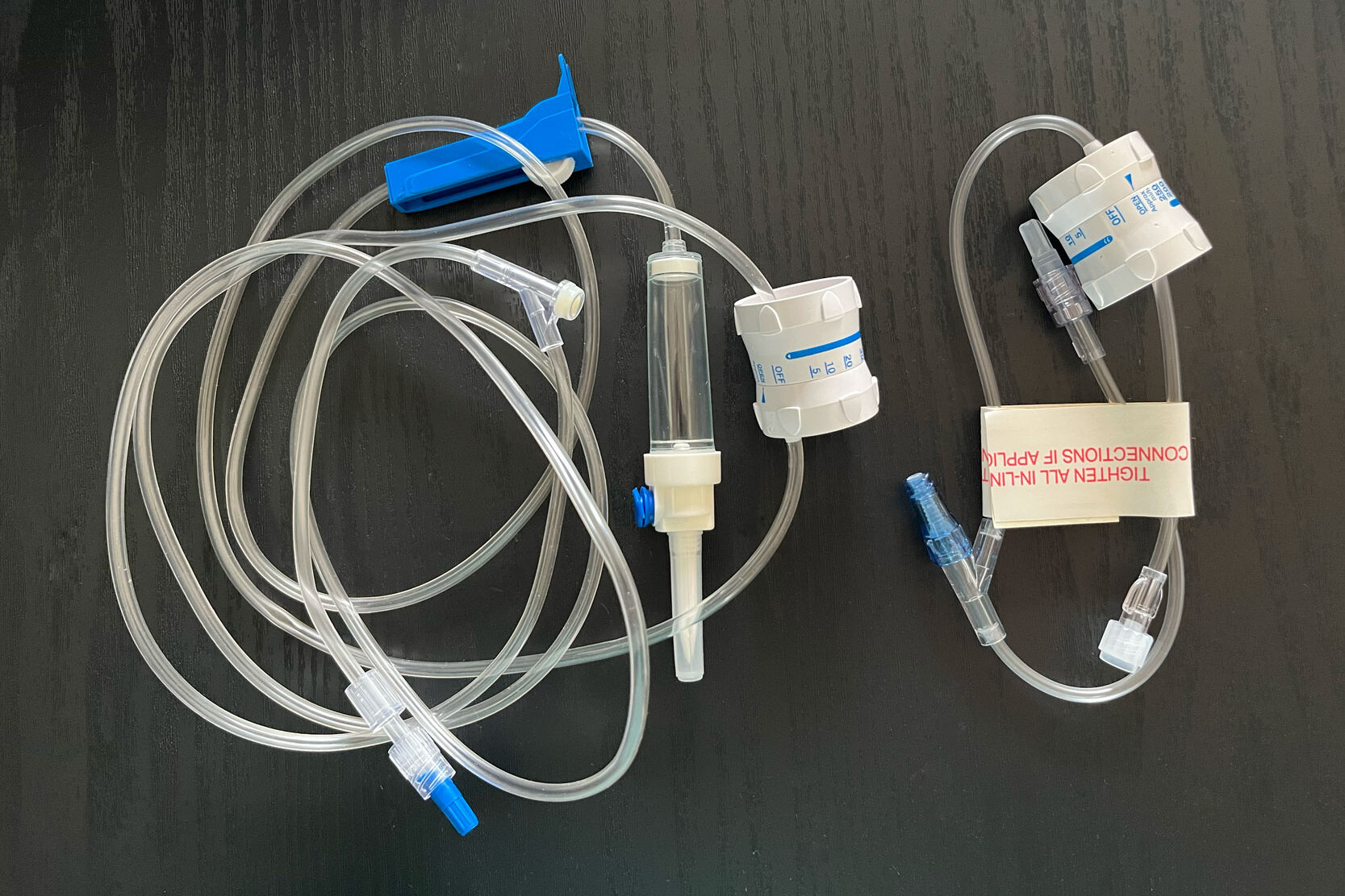Photo showing Dial-a-Flow hooked up to both extension tubing and to IV tubing kit.