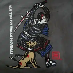 Crisis Medicine K9 TECC for Human Providers Tshirts with a Samurai, sword overhead and a wounded K9 partner at his knee