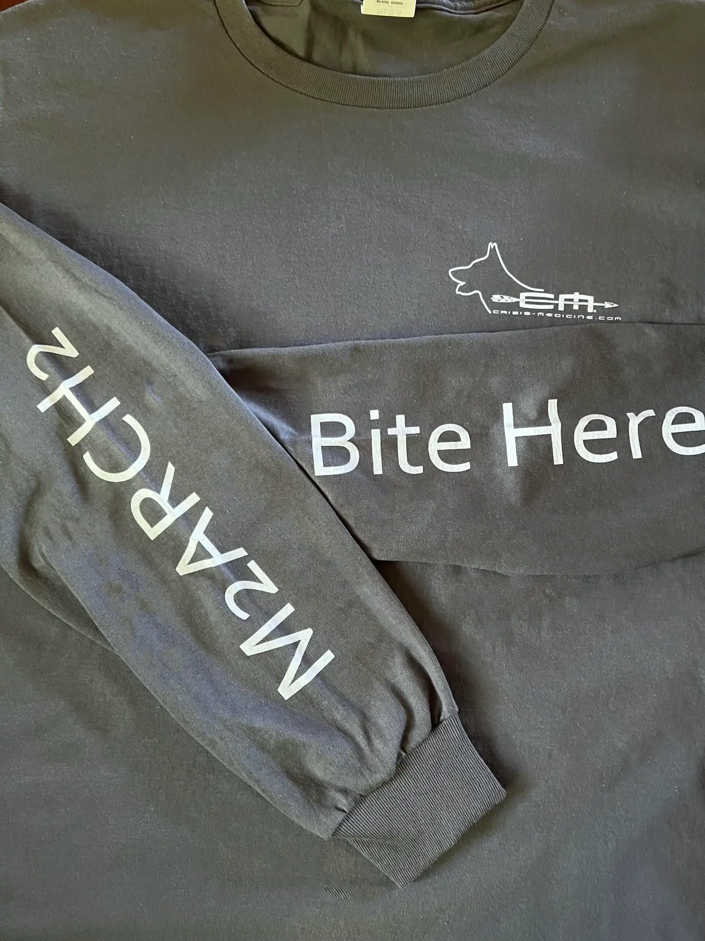 Crisis Medicine K9 TECC for Human Providers Tshirts sleeve detail - Bite Here for your partner M2ARCH2 to remind yourself the critical steps in K9 care