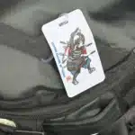 The Crisis Medicine Luggage Tag hanging on luggage