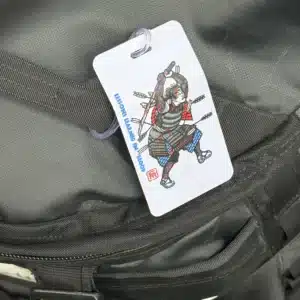 The Crisis Medicine Luggage Tag hanging on luggage