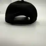 The back of the Crisis Medicine logo'd hat, with solid fabric and a plastic sizing strip