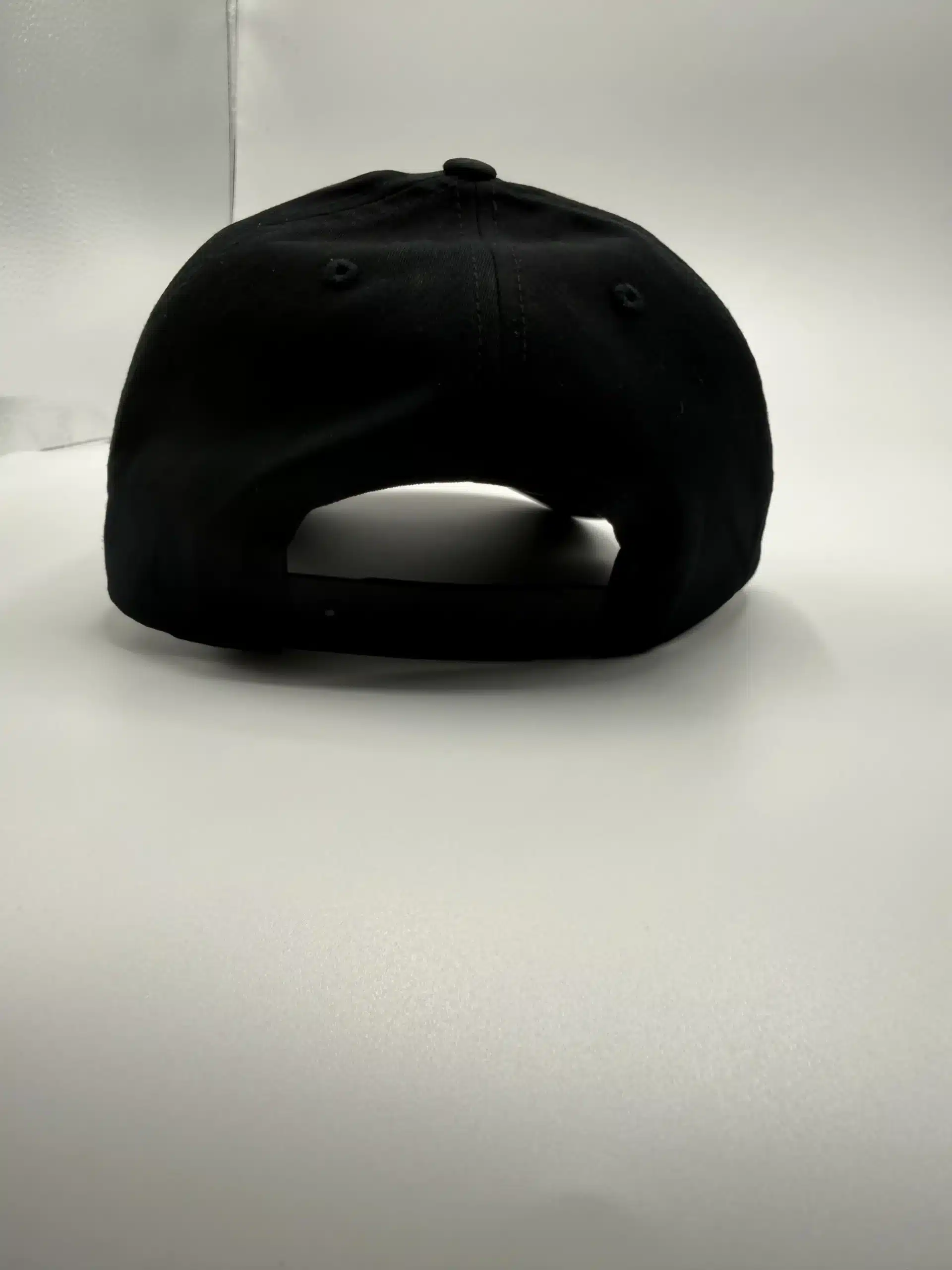 The back of the Crisis Medicine logo'd hat, with solid fabric and a plastic sizing strip