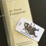 The Crisis Medicine Luggage Tag sitting on a copy the Crisis Medicine Air Travel Emergencies